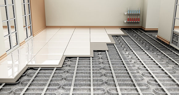 a floor being laid over an underfloor heating system of pipes in a home